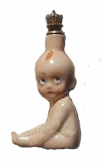 Kewpie facing left with crown